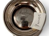 an old silver plate with a tag on it with a note attached to it