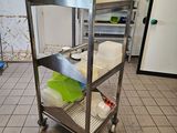 a metal cart that has some food on top of it