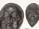 three masks that are on display on a wall