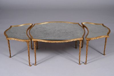 two tables with mirrored tops and gold metal legs