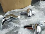 three chrome faucets sitting on a plastic wrap