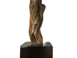 statue of a hand holding a ball on a black marble base