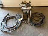 an image of a welding machine and hoses on the floor