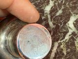 a person holding a pepper shaker in their hand