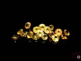some very pretty yellow diamonds on a black surface