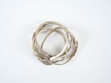 a close up of a silver ring on a white surface