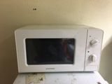 un micro-ondes posé sur un four à micro-ondes