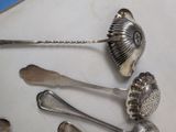 a lot of silver spoons and spoon spoons on a table