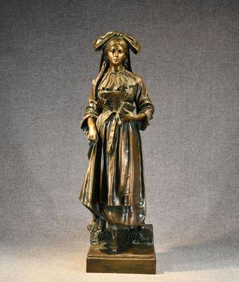 bronze statue of a woman holding a basket of flowers