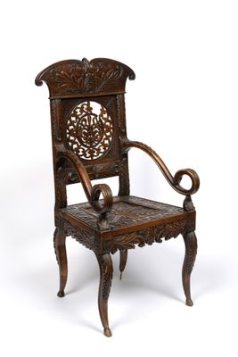 an image of a wooden chair with a carved back and arms