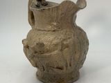 a small vase that is sitting on a white surface