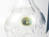 a glass vase and a glass bottle on a table