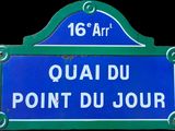 blue and white street sign on a black background that says quai du point du jour
