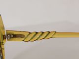 yellow sunglasses with a braid handle on a white background