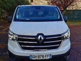 the front view of a white van parked in a parking lot