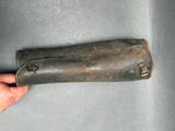 a hand holding a leather case that is on a table