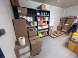 a room filled with boxes and pallets in a warehouse