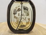 eau rose eau de toilette spray bottle on a wooden table