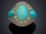 an image of a turquoise stone and diamond ring on a black surface
