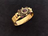 a close up of a gold ring on a black surface