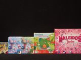 several children ' s video games are lined up on a black surface