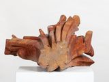sculptures made of wood sit on a white pedestal against a white background