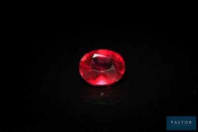 a red ruby gems on a black surface