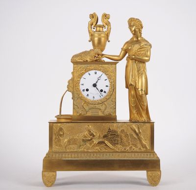 une horloge en or surmontée d'une statue