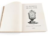 an open book with a drawing of a clock on it