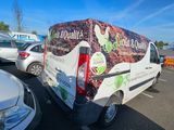 a van that is parked in a lot with other cars