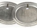 two silver metal trays with tags on them on a white background
