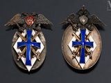 pair of silver and blue enamel badges with eagle and cross on them
