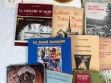 many books on a table with a white table cloth