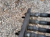a close up of a metal pipe and a person ' s feet