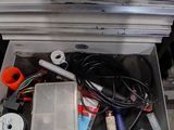 a metal box filled with various tools and wires