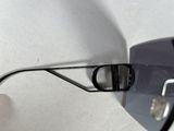 a person holding a pair of glasses on a white surface
