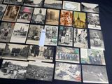 a lot of old black and white pictures on the table