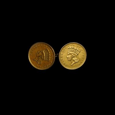 une image représentant deux pièces d'or sur fond noir