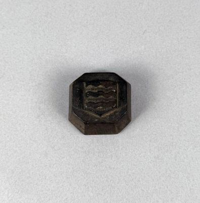 a close up of a small metal object on a white surface