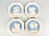 four blue and white plates with a picture of a man on a horse