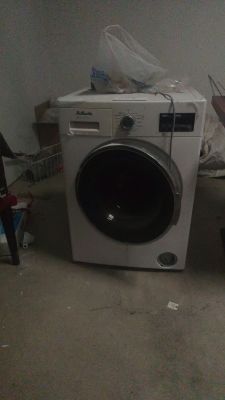 a washing machine sitting in the corner of a room
