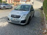 a small silver car parked on the side of the road
