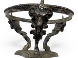 a metal sculpture of a bull head on a pedestal