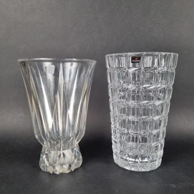 pair of clear glass vases sitting on top of a black table