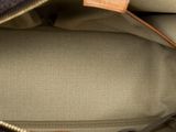 close up of the inside of a brown and tan purse