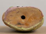 a close up of a vase with a hole in it