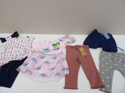 a lot of clothes that are on a white table