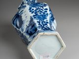 a blue and white vase sitting on a table
