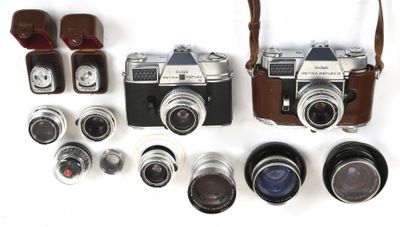 a lot of different types of cameras on the table