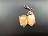 a small gold locke with a keychain attached to it